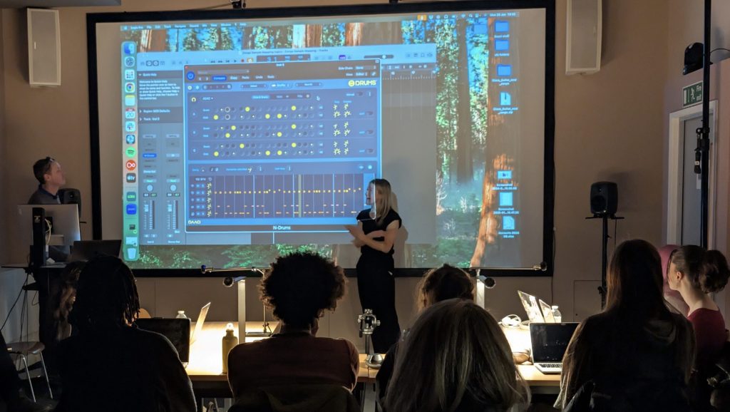 A screen with UAL students looking at the workshop with DAACI